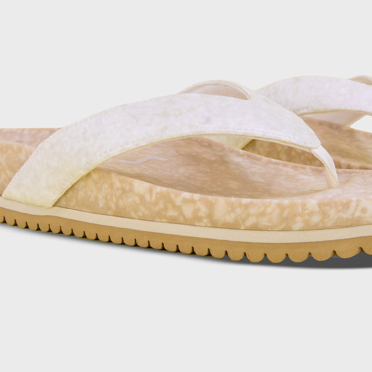 Fleks West Beach Flip Flop in oatmeal color, showing a close-up of the strap and sole from an angled view.