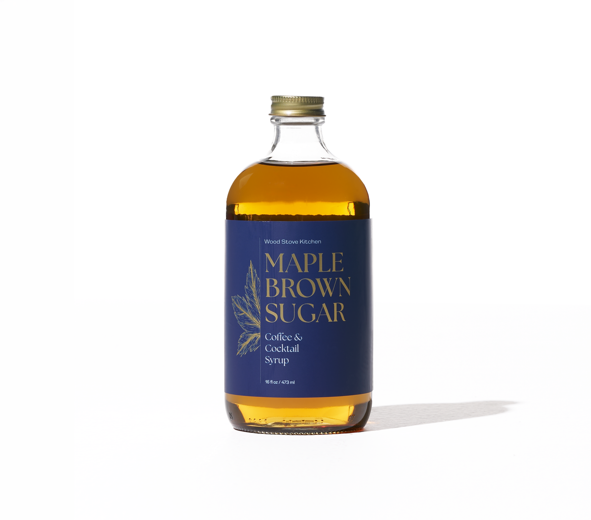 Maple and brown sugar coffee and cocktail syrup from Wood Stove Kitchen in a 16 fl oz bottle, used as a drink mixer and flavor enhancer.