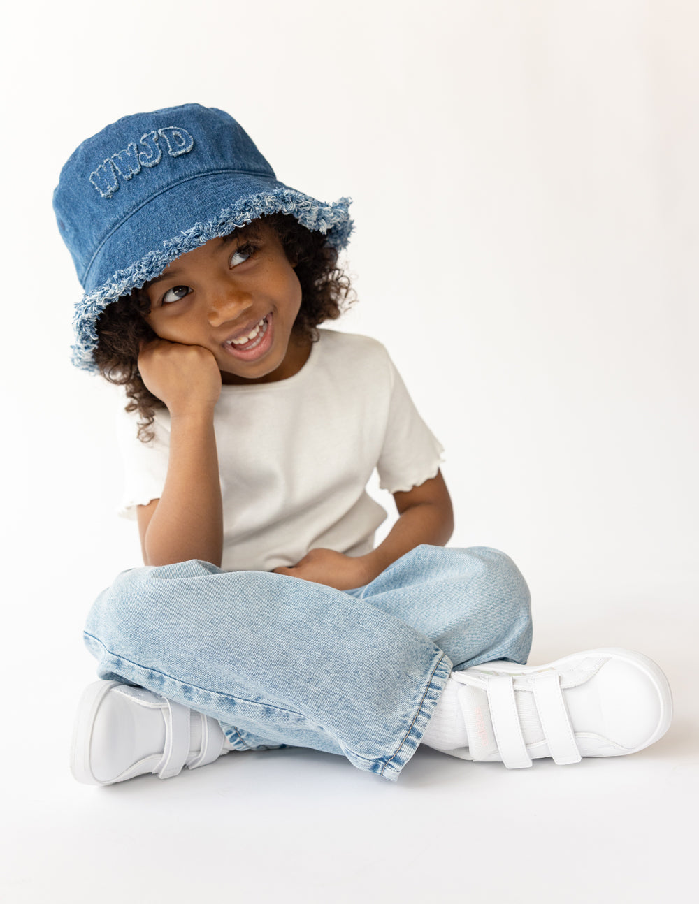 Kids denim bucket hat by Elevated Faith with WWJD design, featuring a wide brim and adjustable chin strap for sun protection.