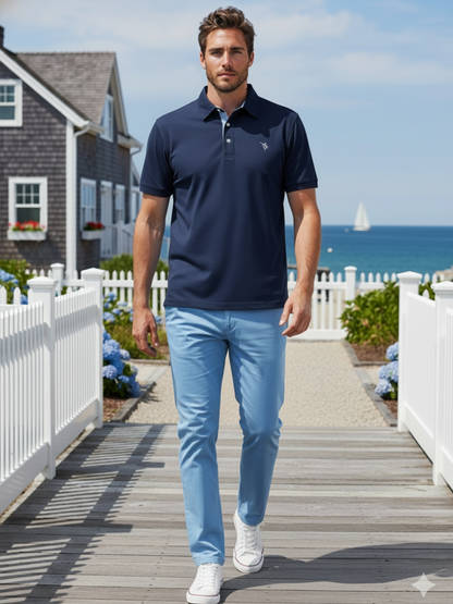 Navy Coastline polo shirt by White Water Life, featuring a classic collar and short sleeves, laid flat for display.