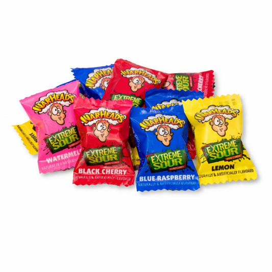 Assorted Warheads Extreme Sour Fruit Flavors hard candies in a bulk Candy In Bulk bag, colorful and individually wrapped.