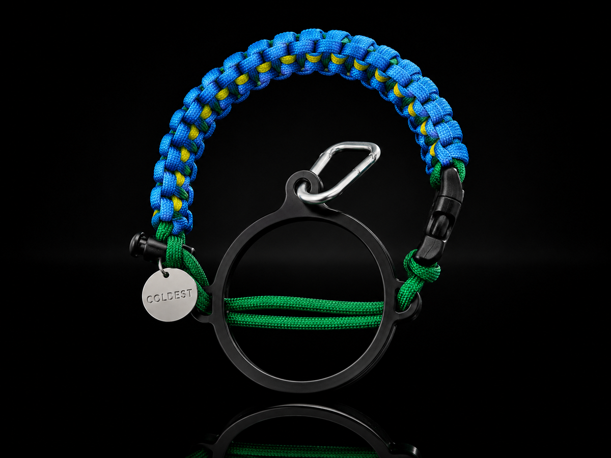 Black Coldest Paracord Handle accessory with woven design, set against a dark wave background.