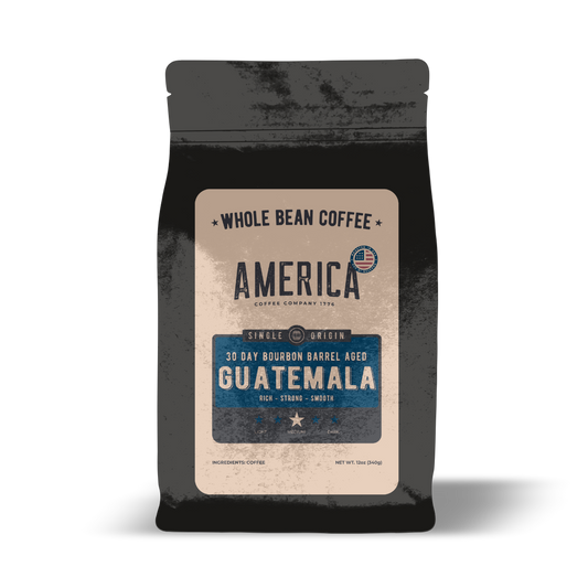 Guatemala single origin coffee aged in whiskey barrels by America Supply Company LLC, showing brewed coffee in a cup with barrel details.