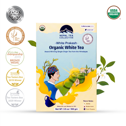 Organic White Prakash tea from Nepal Tea, brewed in a clear cup showing the light, delicate white tea leaves.