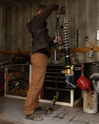 Off The Grid Surplus Trailblazer standard fit pants in durable fabric, shown in a natural outdoor setting.