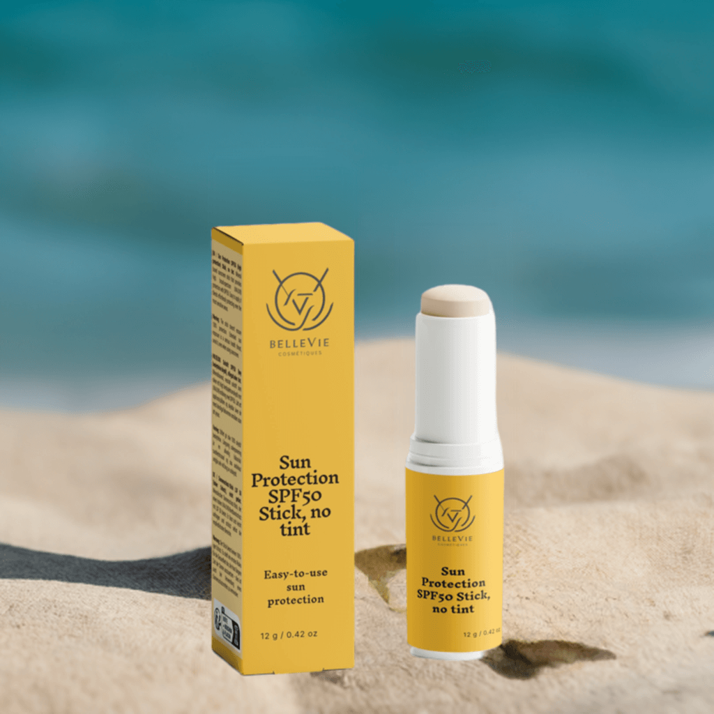 Woman applying BelleVie SPF50 mineral sunscreen stick for broad-spectrum, invisible sun protection.