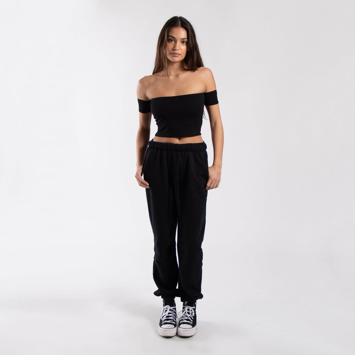 Women’s black off-shoulder cropped tee from POS Wholesale, stylish short-sleeve crop top for casual wear.