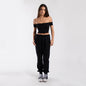Women’s black off-shoulder cropped tee from POS Wholesale, stylish short-sleeve crop top for casual wear.