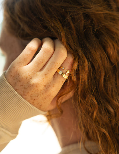 Elevated Faith Wrapped Cross Gem Ring featuring a detailed cross design with sparkling gemstone accents on a silver band.