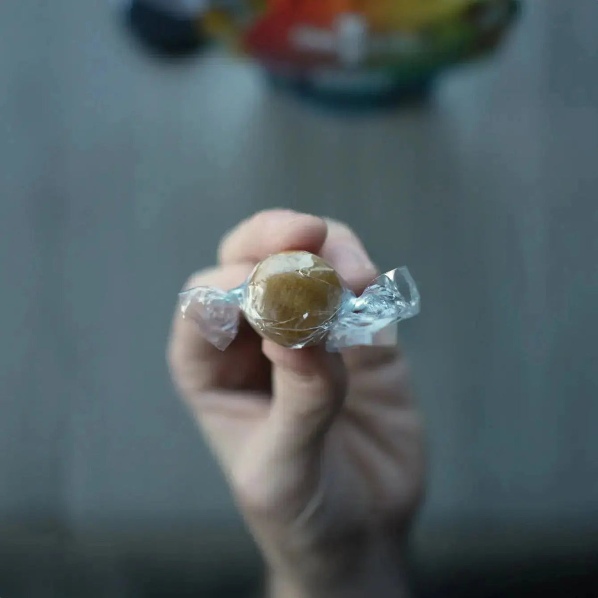 Hand holding a wrapped Drop-in bundle of 1 Shot Energy Voice Stack, a convenient energy supplement bundle.