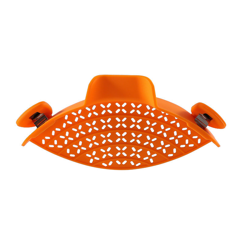 Silicone pot side drain stopper for kitchen gadgets, shown attached to a cooking pot