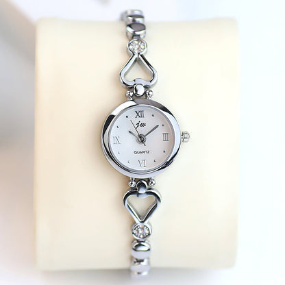 Women's steel strap student watch bracelet in silver-tone metal band, minimalist round dial.