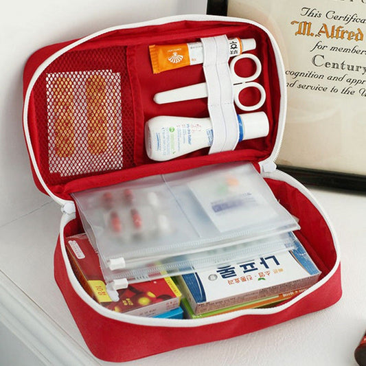 Red empty large first aid kit bag for outdoor camping, travel, emergency medicine storage and survival gear