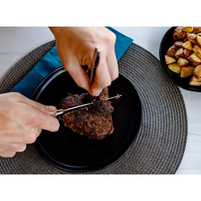 Set of 8 Dura Living gray steak knives with sleek handles, arranged on a wooden cutting board for serving.