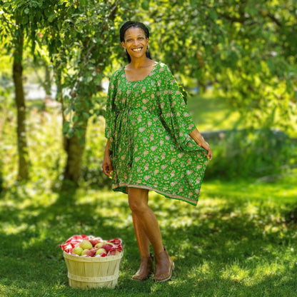 A woman wearing the Darn Good Yarn Surplus Aanya Adjustable Short Kaftan in eco-friendly crochet, plus size, boho style.