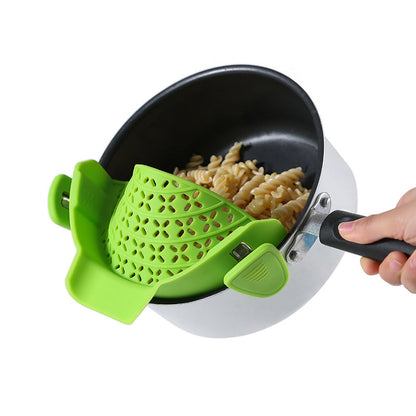 Silicone pot side drain stopper for kitchen gadgets, designed to attach to the side of a cooking pot