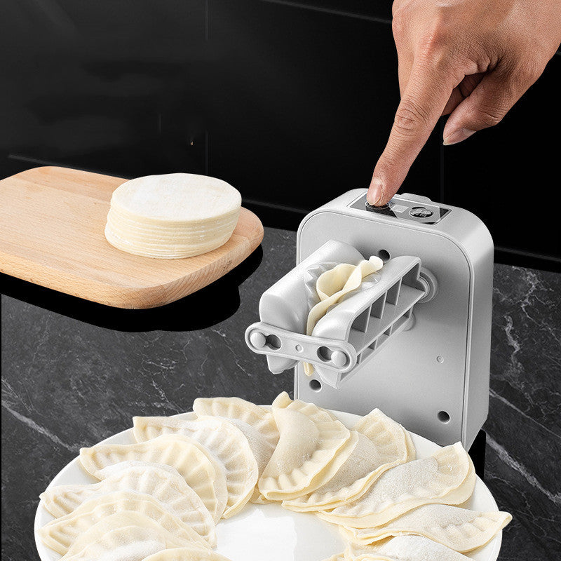 Automatic electric dumpling maker machine for kitchen use, compact white appliance with dumpling molds