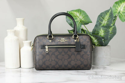 Coach Rowan Brown and Black Signature Leather medium satchel handbag with handles and logo details.