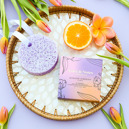 Spongellé Acoustic Harmony Love & Notes body wash-infused buffer showing the textured body buffer with floral and musical design accents.