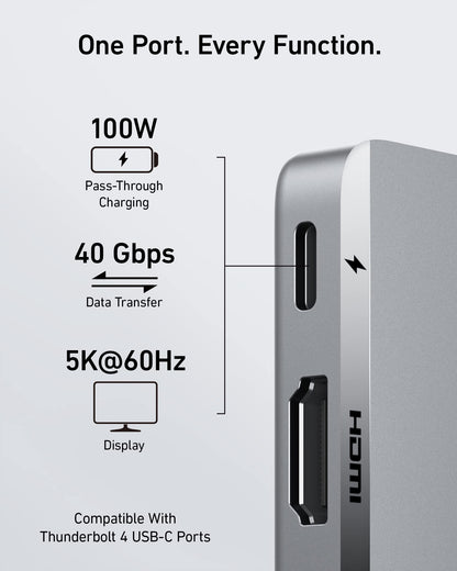 Anker 547 USB-C Hub for MacBook, charging-only 7-in-2 hub with multiple ports, shown connected to a sleek MacBook laptop.