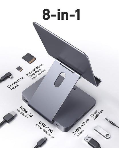 Anker 551 USB-C Hub in gray with multiple ports and integrated tablet stand, designed for charging and connectivity.