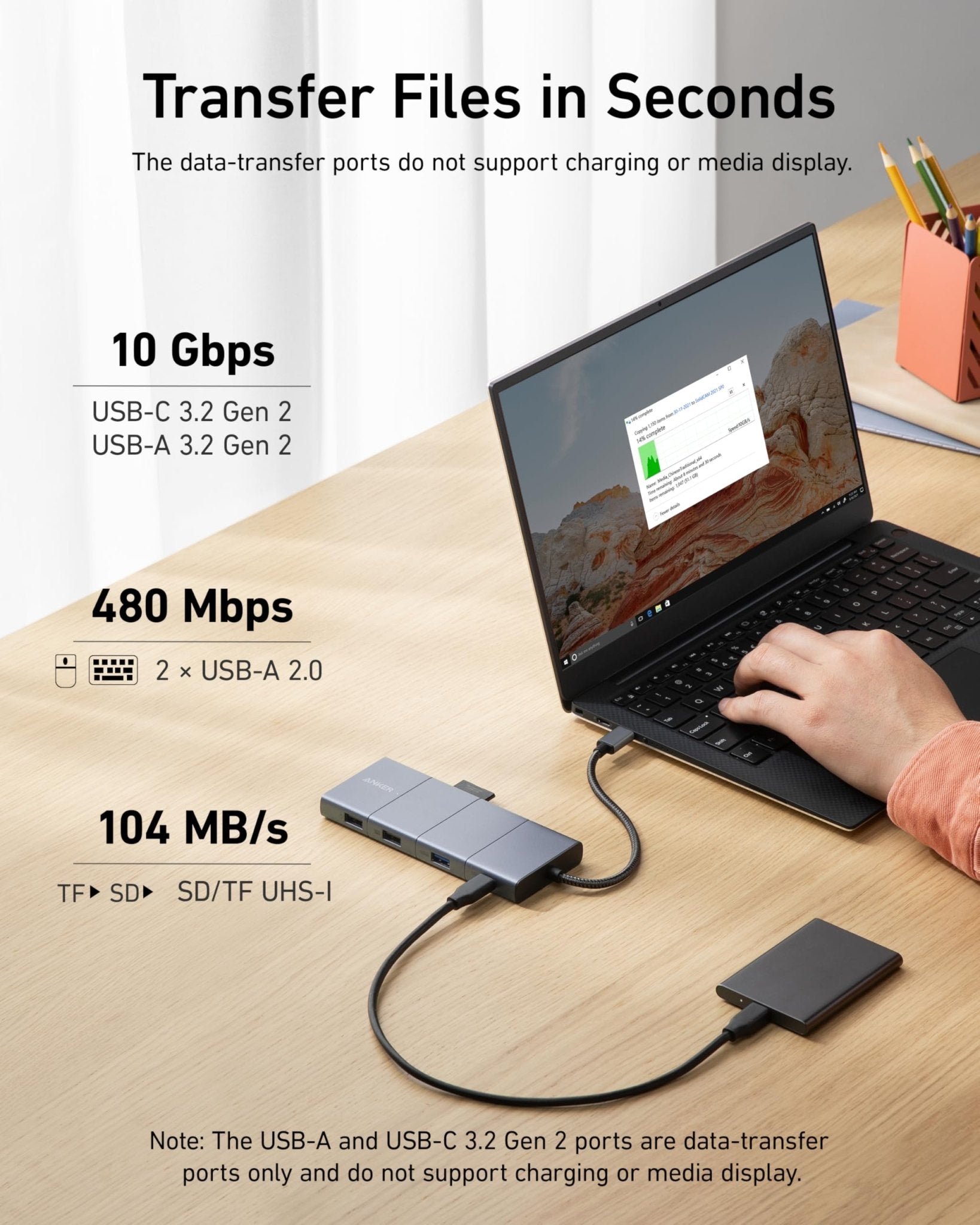 Anker 565 USB-C Hub in grey showing multiple ports for charging and connectivity on a sleek modern device.