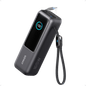 Anker 25K 165W laptop power bank in space black with built-in and retractable cables for portable charging.