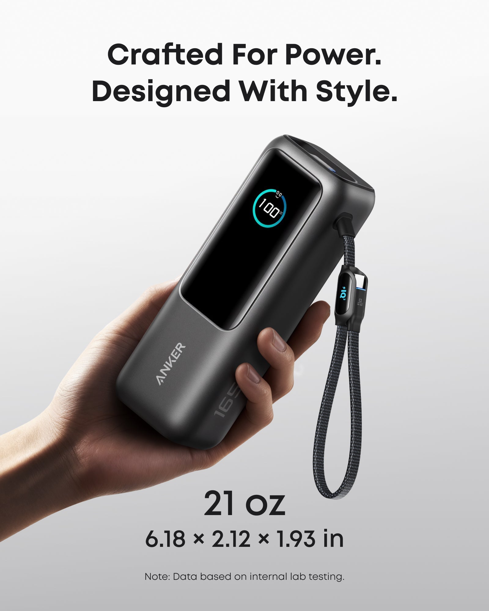 Anker 25K 165W laptop power bank in space black with built-in and retractable cables for portable charging.