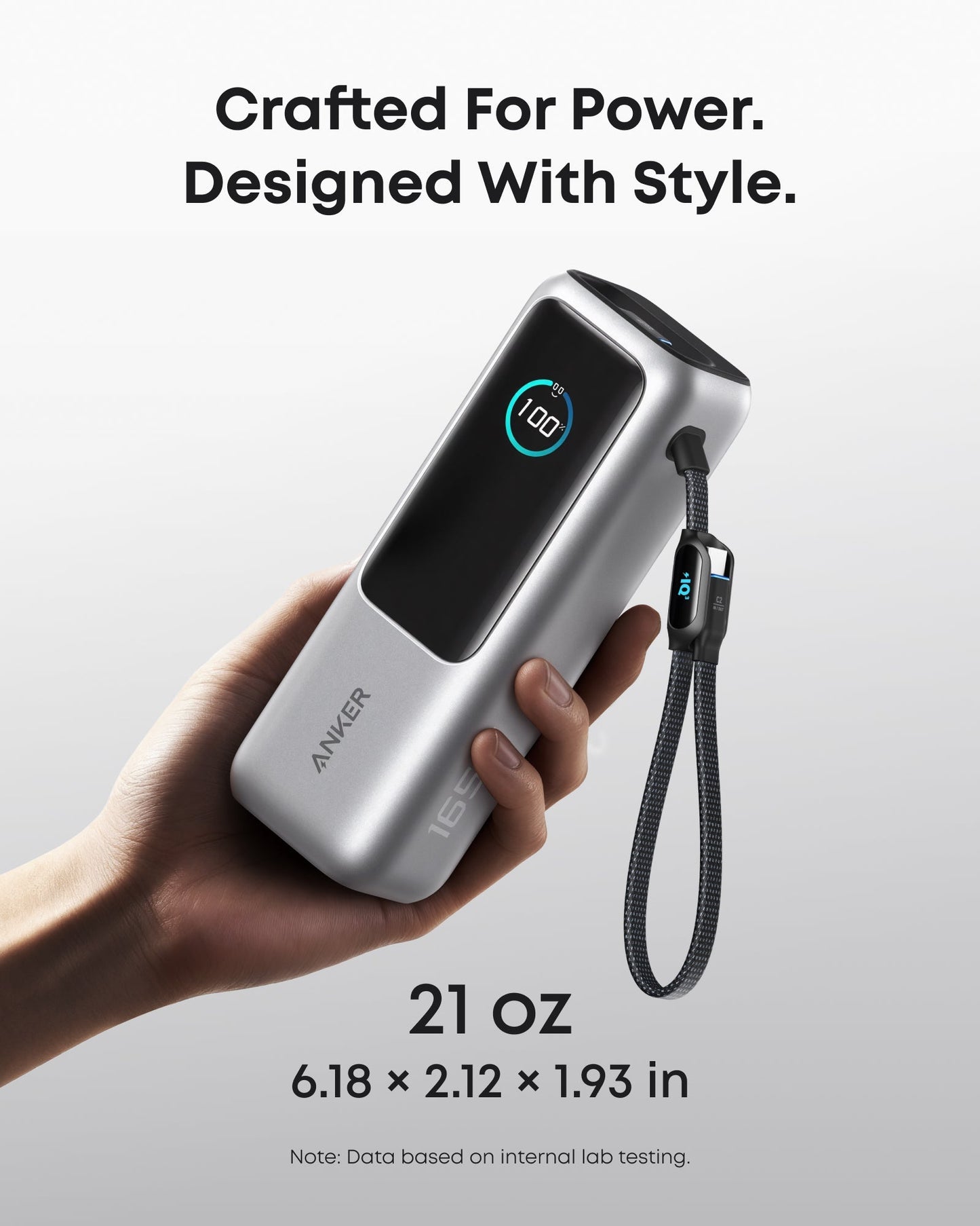 Anker 25K 165W laptop power bank in space black with built-in and retractable cables for portable charging.