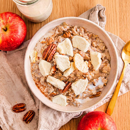 Freeze-dried apple slices on oatmeal bowl, showing crispy apple pieces as a healthy dried fruit snack by VFD.US.