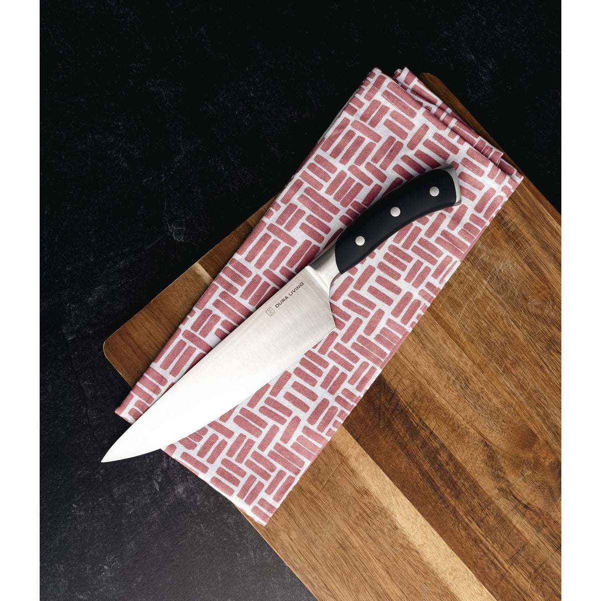 Dura Living Elite 3-Piece Kitchen Knife Set in black with stainless steel blades and ergonomic handles on a wooden countertop.