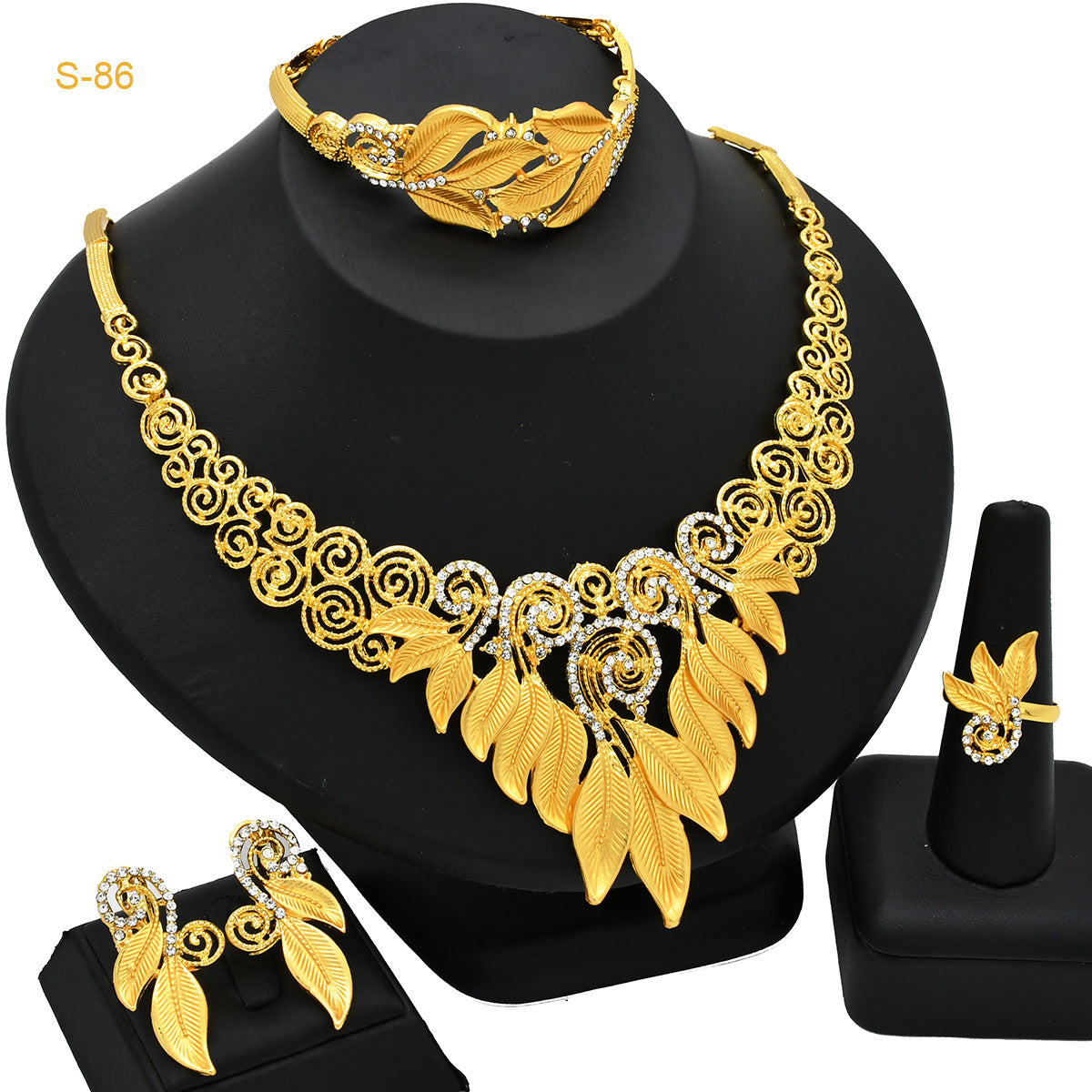Women's Saudi bridal necklace, bracelet, earrings and ring four-piece jewelry set glistening on display
