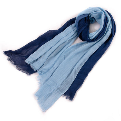 Large soft warm cotton tassel scarf in a neutral tone laid flat