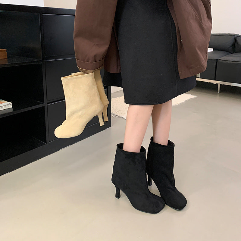 Versatile solid-color commuter-style booties with a low heel and ankle-length design
