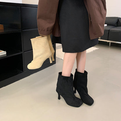 Versatile solid-color commuter-style booties with a low heel and ankle-length design