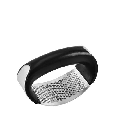 Stainless steel garlic press with curved manual handle for crushing garlic and vegetables in the kitchen