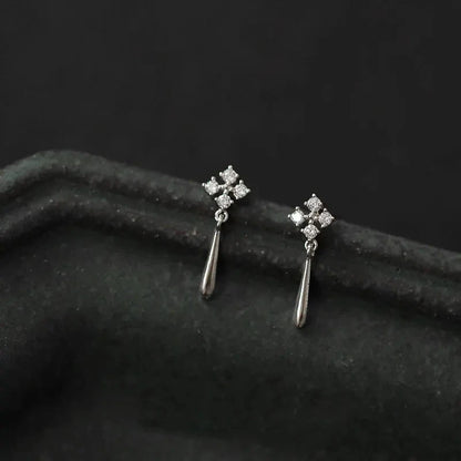 Silver inlaid zircon clover tassel earrings for women, delicate chain pendant jewelry, perfect for parties and special occasions.
