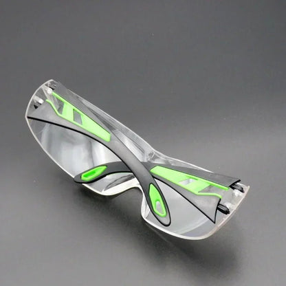 Unisex anti-splash goggles with clear lenses, safety frame, suitable for industrial work, cycling, windproof, and dust protection.