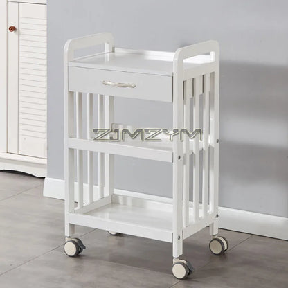 White modern beauty salon trolley cart with wheels, movable storage rack and drawers for salon tools and accessories.