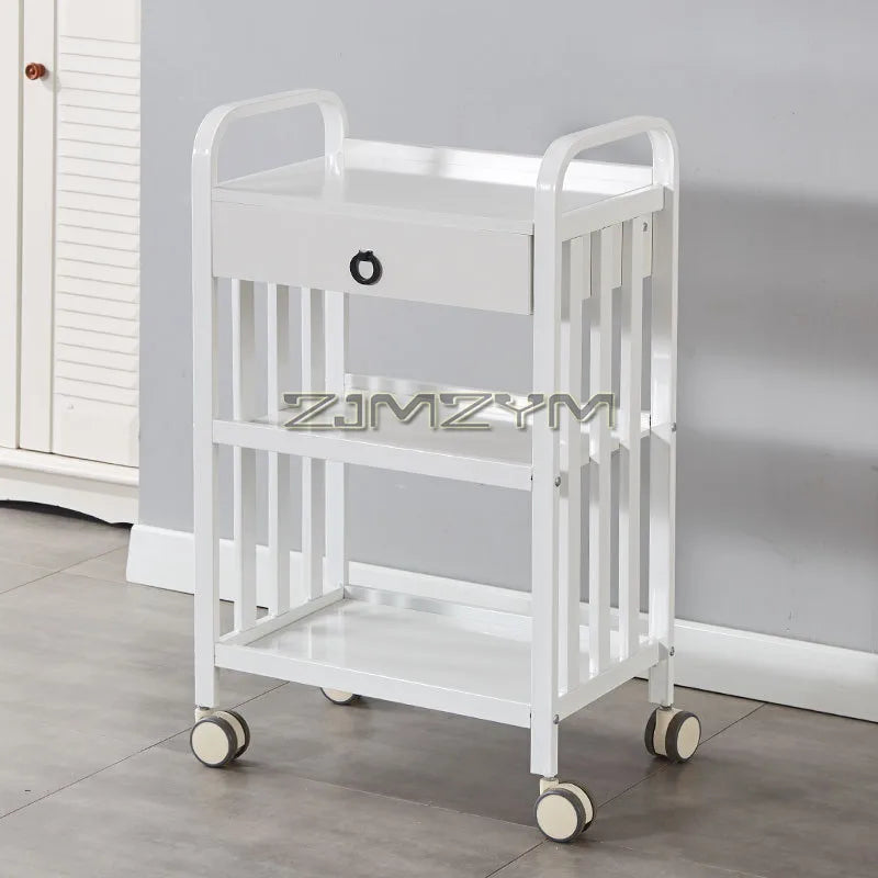 White modern beauty salon tools trolley with wheels, movable drawer storage, and a creative bar cart design for salon organization.
