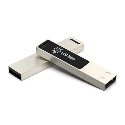 Silver USB flash drive with glowing logo, 16GB capacity, designed for photo storage and external data backup.