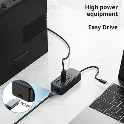 BackupMyFilesNow USB-C to 4-Port USB 3.0 hub with power supply, showing multiple USB ports and sleek design for laptops.