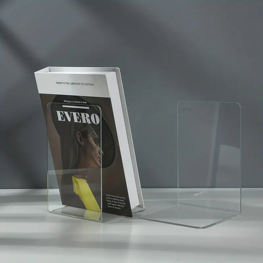 A clear acrylic desktop book stand holding an open book, designed by BACKUPMYFILESNOW.COM® for easy reading and display.