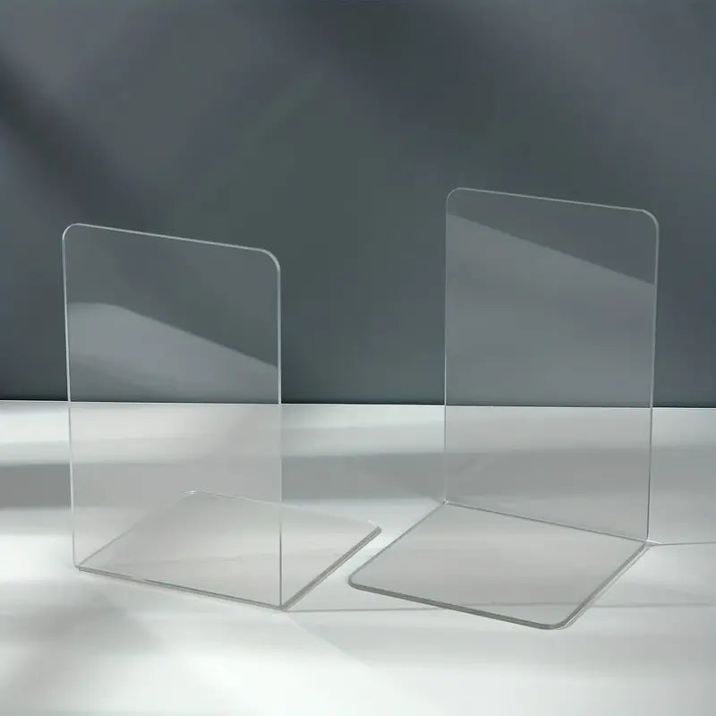 Clear acrylic desktop book stand from BACKUPMYFILESNOW.COM® holding an open book on a workspace.