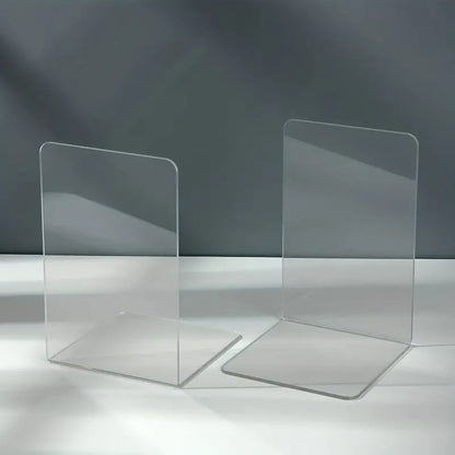 Clear acrylic desktop book stand from BACKUPMYFILESNOW.COM® holding an open book on a workspace.