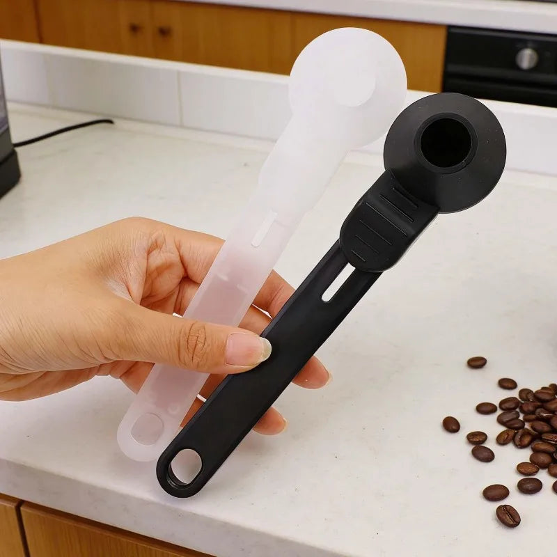 White sliding leakproof coffee scoop with large capacity, ideal for measuring coffee, protein, or milk powder in home kitchen settings.