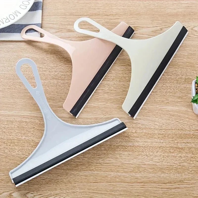 Green silicone water wiper plate and glass cleaner scraper for car windshields, windows, bathroom, and kitchen surfaces.
