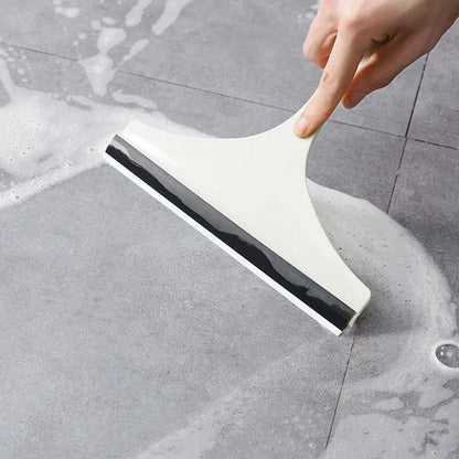 Green silicone water wiper plate and glass cleaner scraper for car windshields, windows, bathroom, and kitchen surfaces.