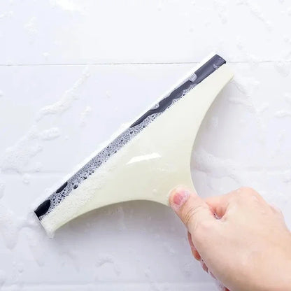 Green silicone water wiper plate and glass cleaner scraper for car windshields, windows, bathroom, and kitchen surfaces.