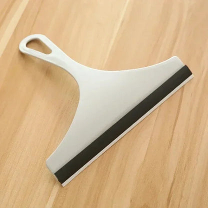 Green silicone water wiper plate and glass cleaner scraper for car windshields, windows, bathroom, and kitchen surfaces.